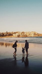 Silhouette of a couple with their child at the beach